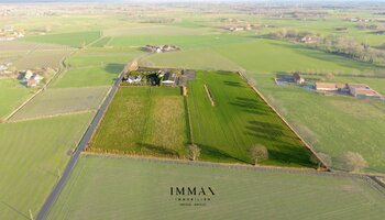 Villa op landelijke ligging met loodsen en weiland vlakbij Damse Vaart